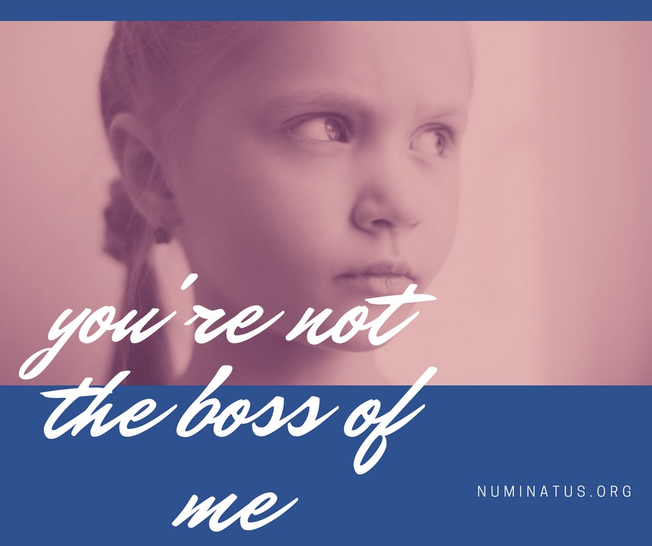 A young girl with a pink earring and the words " you 're not the boss of me."