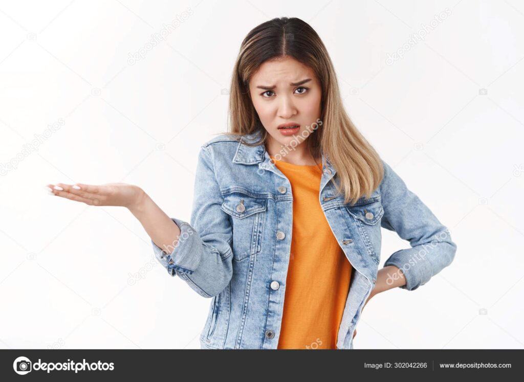 A woman holding out her hand in front of the camera.