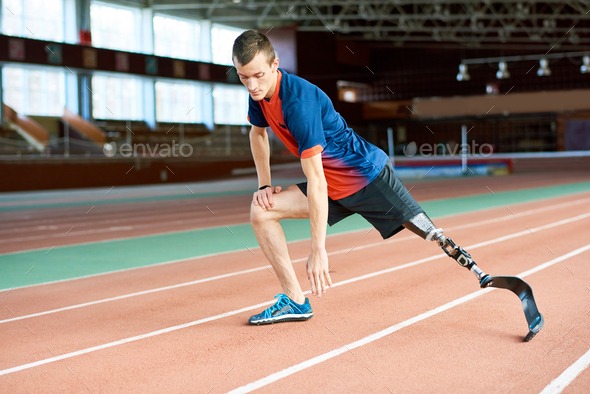 A man with a prosthetic leg running on the track.