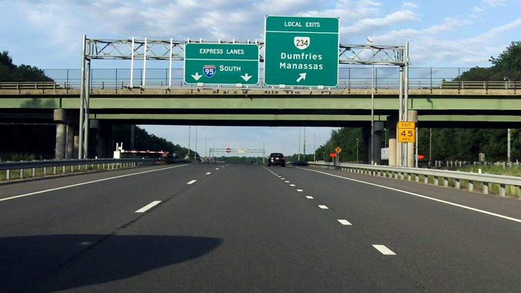 A highway with two green signs on top of it.