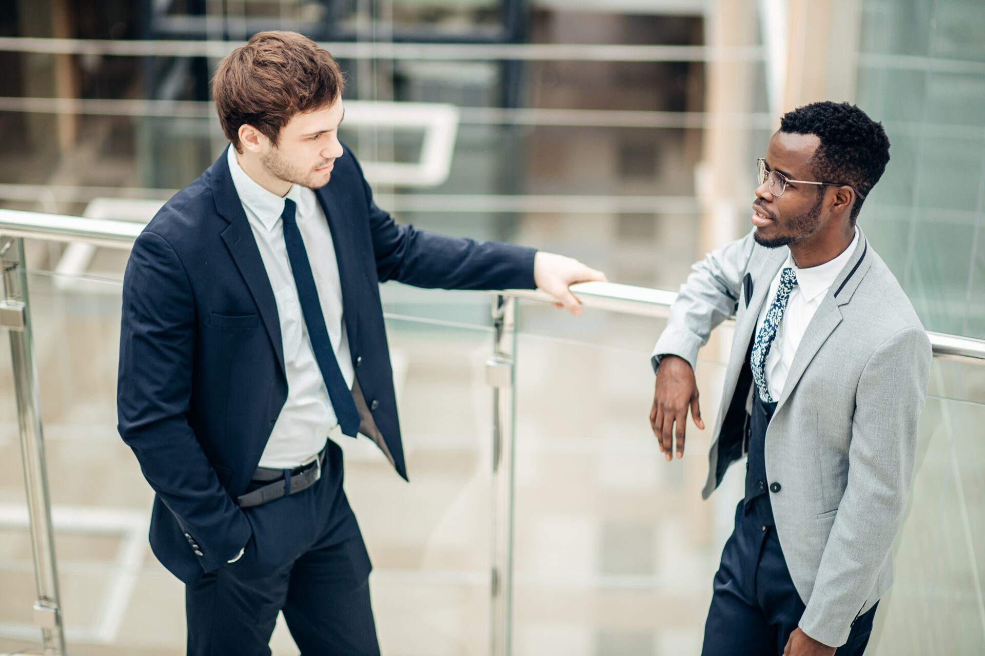Two multiethnic male employees consulting in office